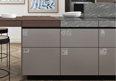 an image of a kitchen setting with stainless steel cabinets and bar stools in the foreground