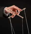 a person is pulling strings from a string with one hand and the other holding an object