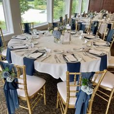 the tables are set with blue and white linens