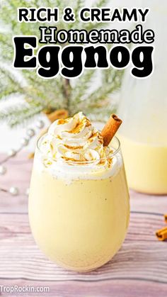 an eggnog drink in a glass with whipped cream and cinnamon on top