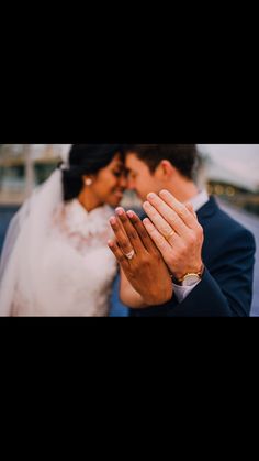 a bride and groom holding their hands together