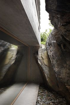 an empty walkway between two large rocks