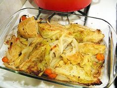 a casserole dish with carrots and onions