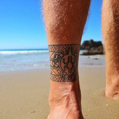 a close up of a person's foot with a tattoo on the side of their leg