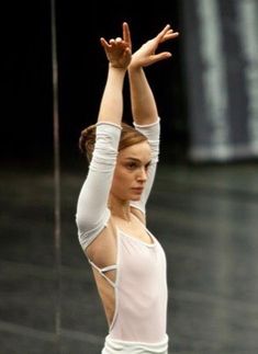 a young woman is practicing her ballet moves