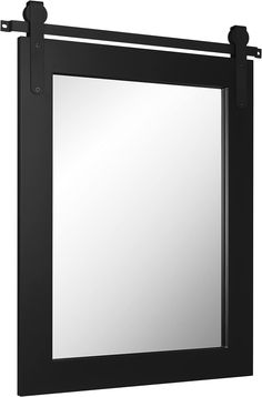 a mirror that is hanging on the side of a wall with black metal bars around it