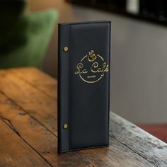 a black book sitting on top of a wooden table