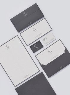 the stationery is laid out neatly on top of each other, including envelopes and business cards