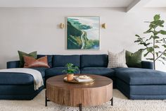 a living room filled with furniture and a large painting on the wall above the couch