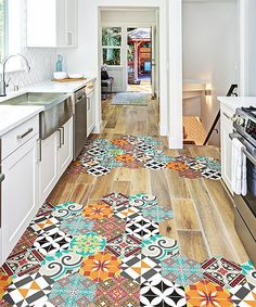 the kitchen floor is decorated with colorful tiles and has an intricate design on it's surface