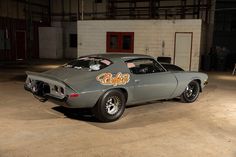 a gray car parked inside of a garage