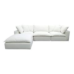 a white sectional couch with pillows on it's back and the seat folded out