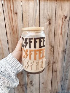 a hand holding a coffee mug with the word coffee on it and an inscription that says coffee