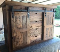 a large wooden cabinet with sliding doors on it's sides