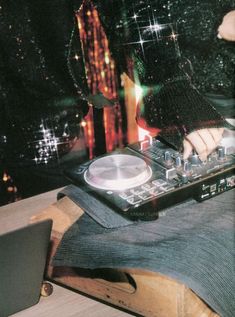 a person is playing music on a dj's turntable in front of a christmas tree