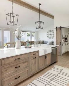 a large kitchen with wooden cabinets and white counter tops, along with an open floor plan