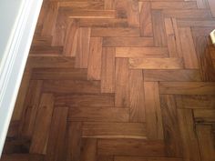 a wooden floor that has been cleaned and is in the process of being installed by someone