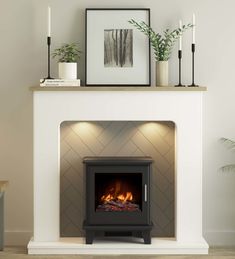 a white fireplace with a fire in it