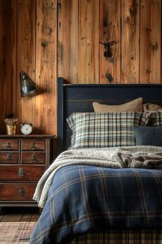 a bedroom with wood paneling and plaid bedding