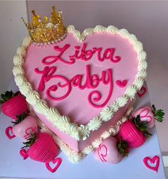 a heart shaped cake with pink frosting and hearts on it that says libra baby