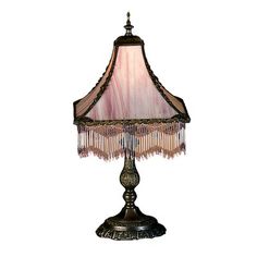 a table lamp with a pink shade on it's base and beaded trim