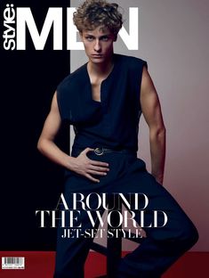 a young man is posing on the cover of men's style magazine, with his hands on his hips