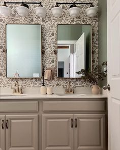 a bathroom with two sinks and mirrors on the wall