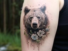 a woman's arm with a bear and flowers tattoo on the left side of her body