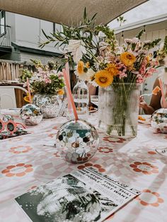 a table with flowers and magazines on it