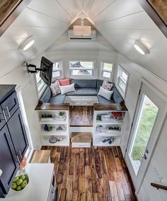 the interior of a tiny house with wood flooring and white walls is shown from above