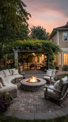 an outdoor fire pit surrounded by furniture