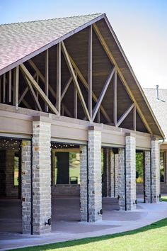 an outside view of a building with several pillars and windows on the side of it