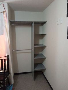 an empty closet with shelves and clothes rails