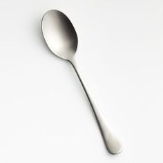 a silver spoon on a white surface