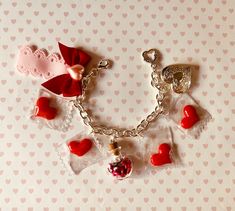 Valentine's Bracelet - Valentines Jewelry -Red Heart charms Bracelet - Girly Bracelet -Gift for Love - Love Jewelry -Heart Locket Charm Jewelry - Gift for Her Celebrate Love with this Valentine's Bracelet, featuring red heart charms, a unique heart shaped bottle filled with tiny hearts and love letters, and a heart locket charm, finished with a lovely ribbon and bow. The color silver bracelet measures 19 cm (7.5 inch) if you need a bigger or smaller size, I can adjust it for you. you will get ex Love Charm Bracelet, Adjustable Bracelet For Valentine's Day, Cute Charm Bracelets For Gifts, Cute Charm Bracelets As Gifts, Cute Bracelets With Charms As Gifts, Cute Handmade Bracelets For Valentine's Day, Handmade Cute Bracelets For Valentine's Day, Heart Charm Chain Bracelet For Wedding And Valentine's Day, Silver Bracelet For Valentine's Day