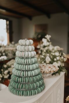 a stack of macaroons sitting on top of a white mantle