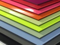 a stack of multicolored papers sitting on top of each other in different colors