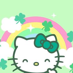 a hello kitty wallpaper with clovers and a rainbow in the backgroud