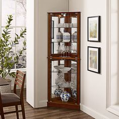 a tall wooden display case with wine glasses on it's front and side shelves