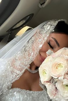 the bride is getting ready to go into her wedding day with flowers in her hand