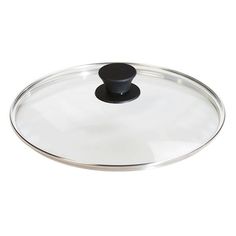 an empty glass lid with black knobs on the top and bottom, against a white background