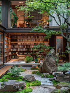 an indoor garden with rocks and plants in the center, surrounded by bookshelves