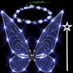 a blue butterfly with white lights on it's wings is next to a wand