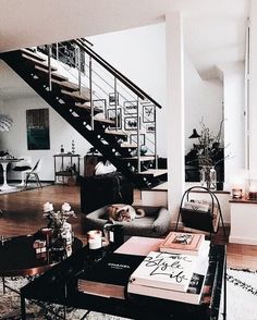 a living room filled with furniture and a stair case