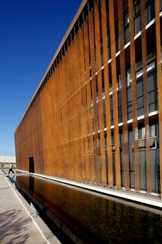 the building is made out of wood and has water running down it's side