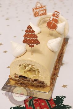 a piece of cake that is sitting on a table with christmas decorations around the edges