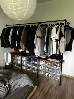 a bedroom with clothes hanging on the wall