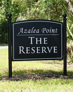 a black and white sign that says azalea point the reserve