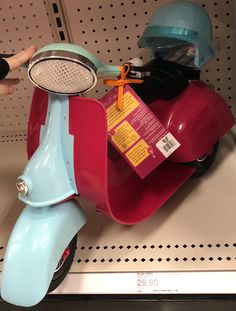 a red scooter with a blue sidecar on display in a store shelf