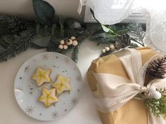 some cookies are sitting on a plate next to christmas decorations